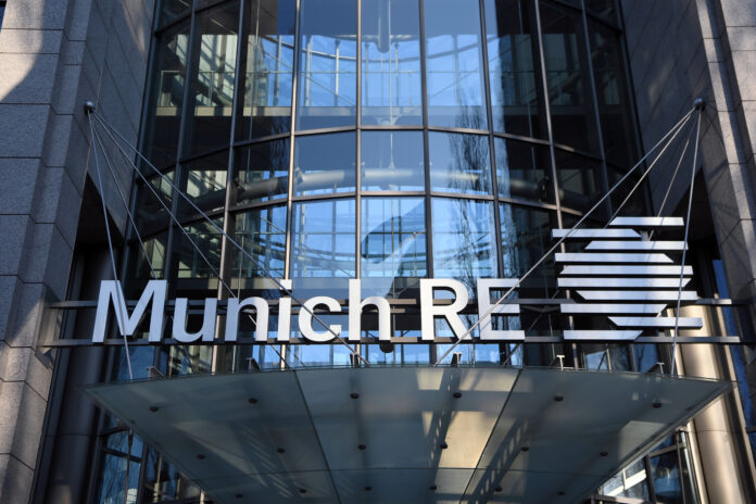 The logo of reinsurance company Munich Re Group is seen next to the entrance of their headquarters in Munich Munich Re- Net Zero Banking