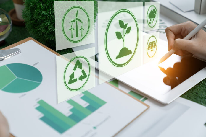 Businesswomen use a digital tablet to analyze ESG design.