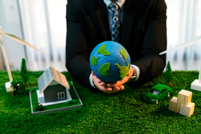 Businessman or CEO holding paper globe in office. Quaint